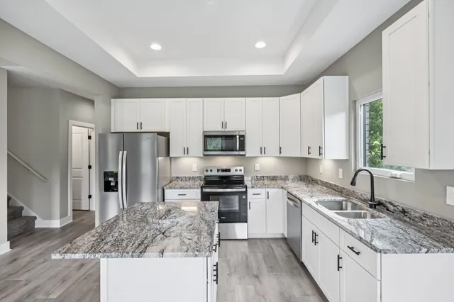 a kitchen with refrigerator a sink and cabinets
