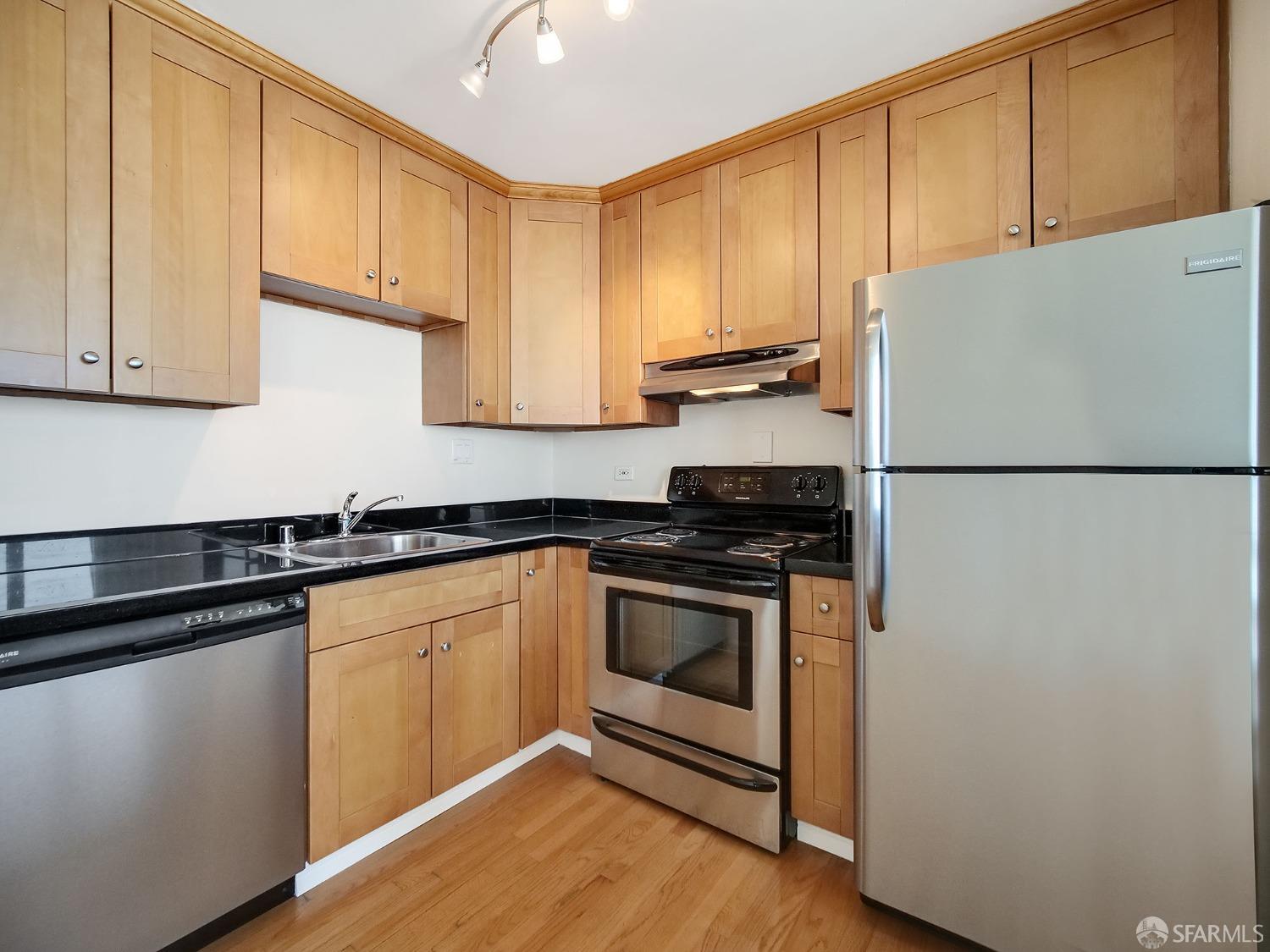 1800 Pacific Avenue, Unit 701 San Francisco, CA 94109 - Photo 15 of 36 a kitchen with a sink a stove and cabinets