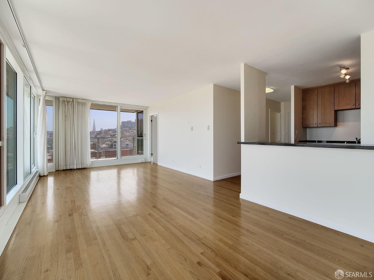 1800 Pacific Avenue, Unit 701 San Francisco, CA 94109 - Photo 2 of 36 an empty room with wooden floor and windows