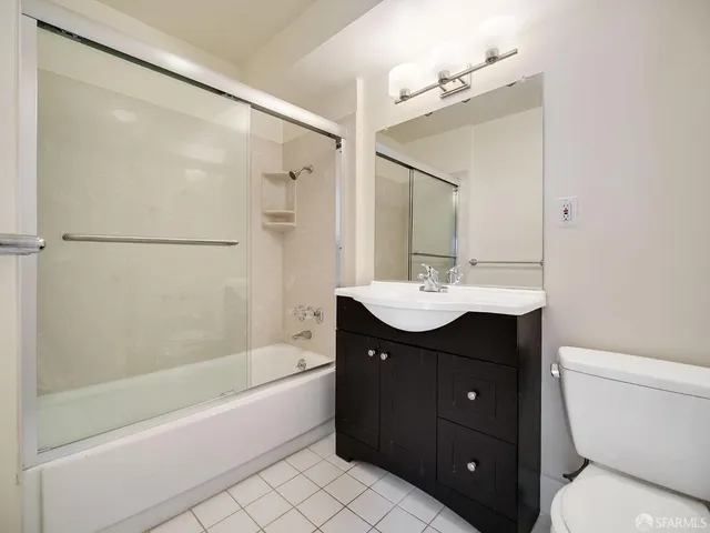a bathroom with a sink and a mirror with bathtub