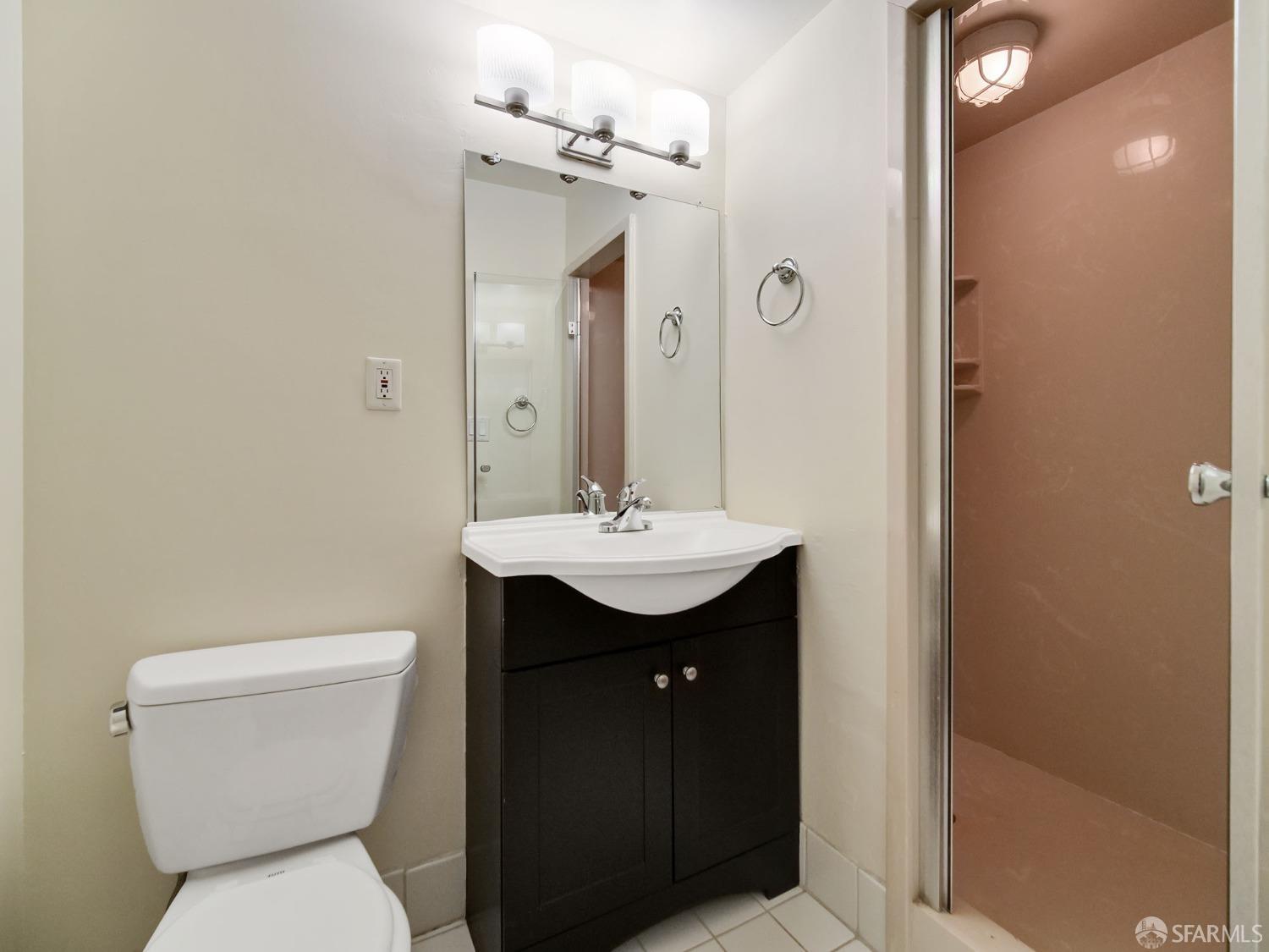 1800 Pacific Avenue, Unit 701 San Francisco, CA 94109 - Photo 32 of 36 a bathroom with a toilet sink and mirror