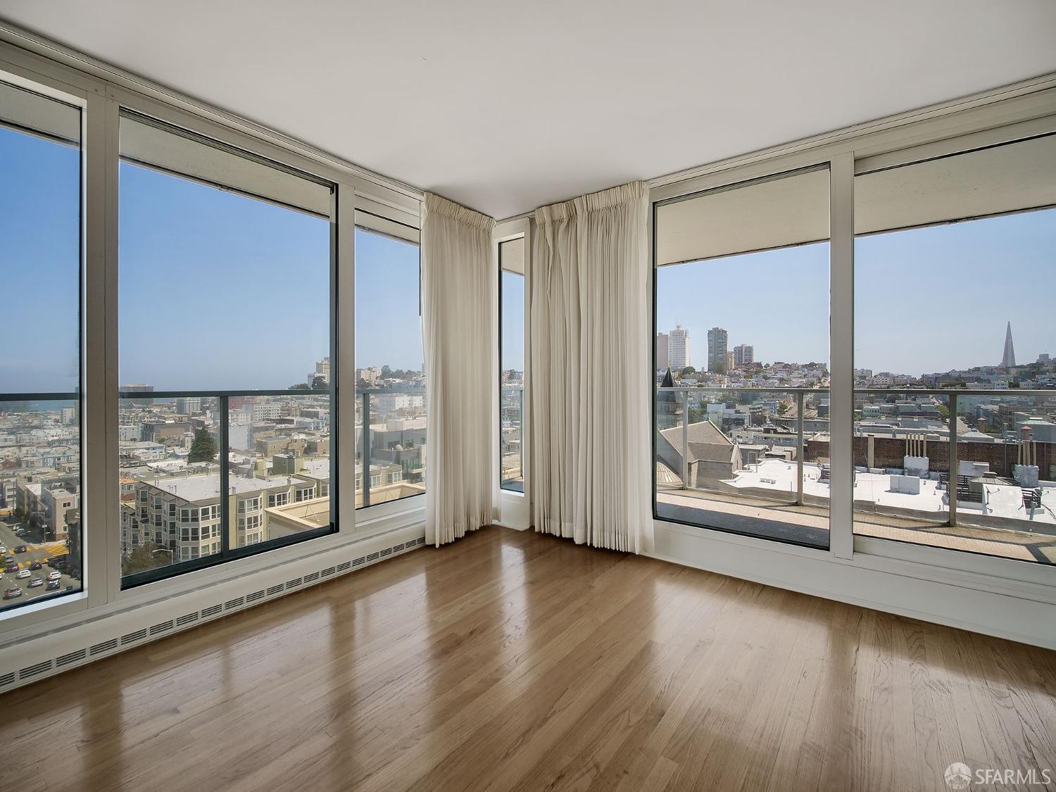 1800 Pacific Avenue, Unit 701 San Francisco, CA 94109 - Photo 5 of 36 a view of an empty room with wooden floor and a window