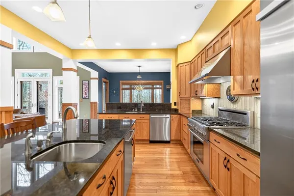 a kitchen with stainless steel appliances granite countertop a sink and cabinets