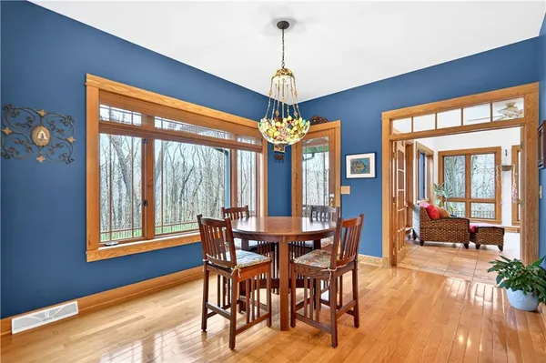 a view of a dining room with furniture wooden floor and chandelier