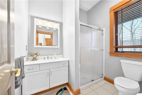 a bathroom with a sink toilet a mirror and shower