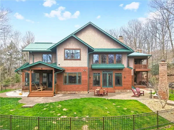 a front view of a house with yard and green space