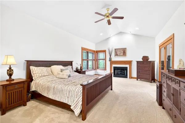 a bedroom with a large bed and a chandelier