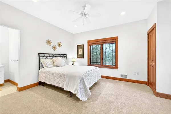 a bedroom with a large bed and a window
