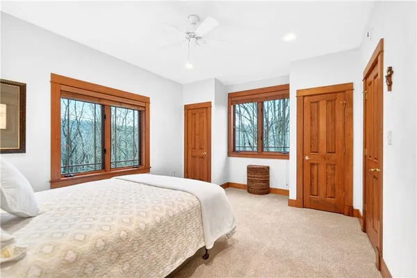 a bedroom with a large bed and a large window