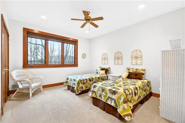 a bedroom with two beds and a chandelier