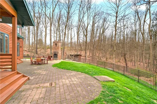 a dining room with furniture large windows and wooden floor