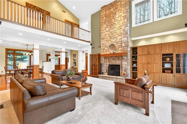 a living room with furniture ceiling fan and a fireplace
