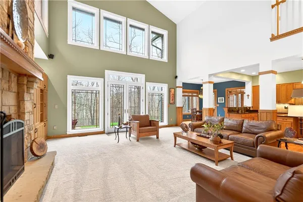 a living room with furniture and a floor to ceiling window