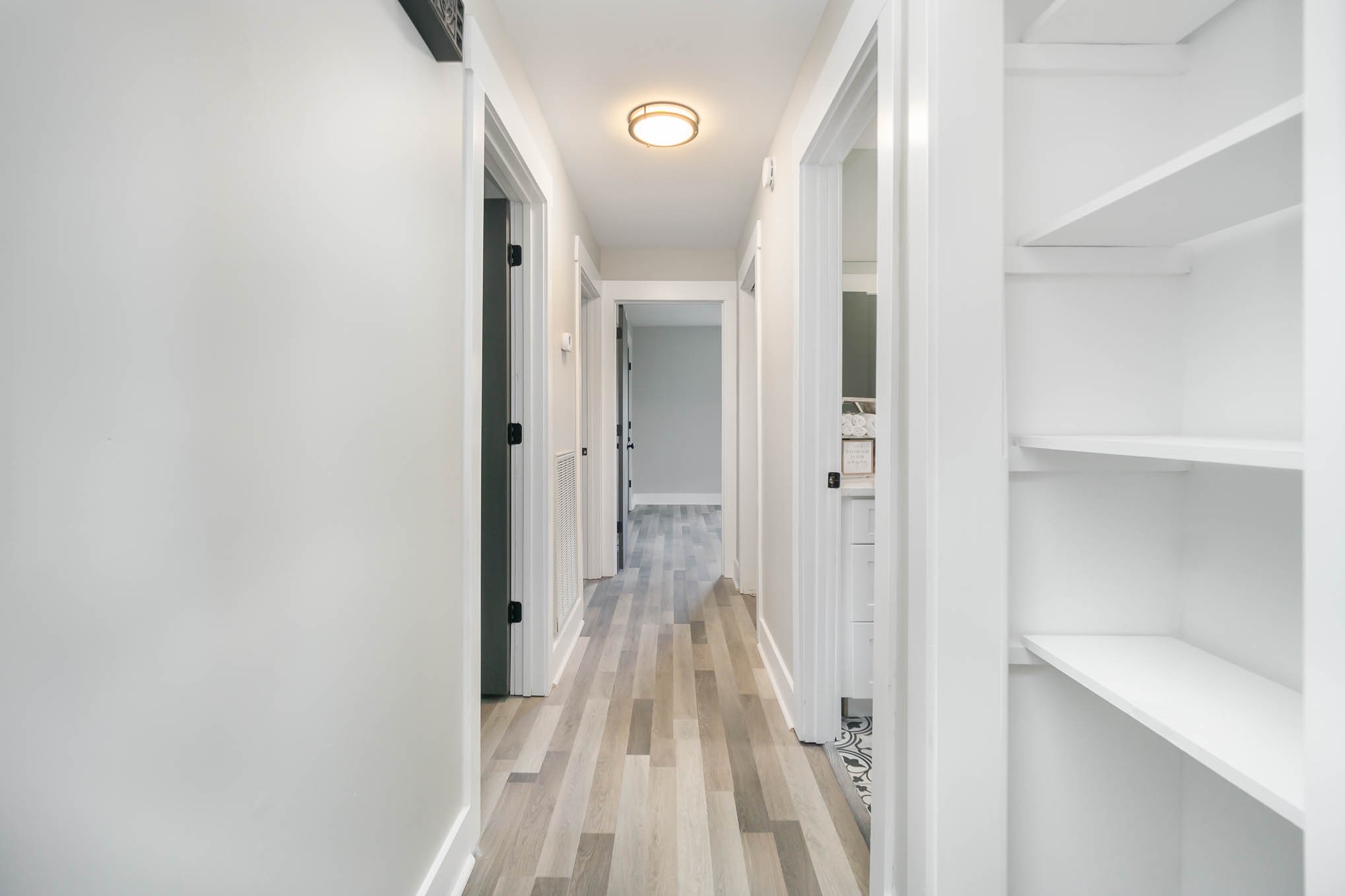 1261 Harrison Road Murfreesboro, TN 37128 - Photo 11 of 24 a view of a hallway with wooden floor and a bathroom