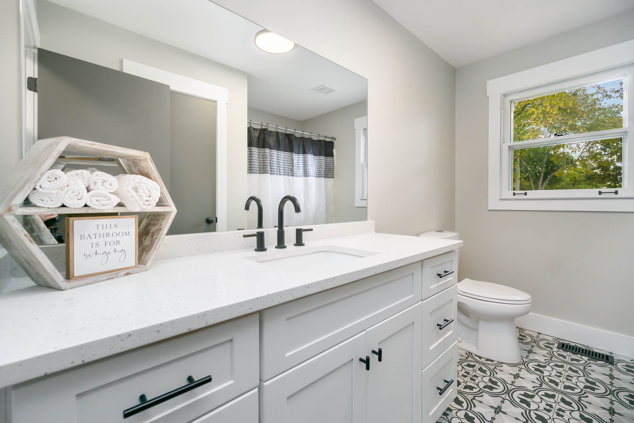 1261 Harrison Road Murfreesboro, TN 37128 - Photo 12 of 24 a bathroom with a sink a toilet and a mirror