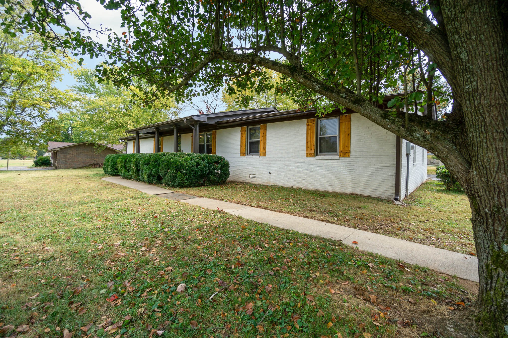 1261 Harrison Road Murfreesboro, TN 37128 - Photo 2 of 24 a house is sitting in middle of the forest