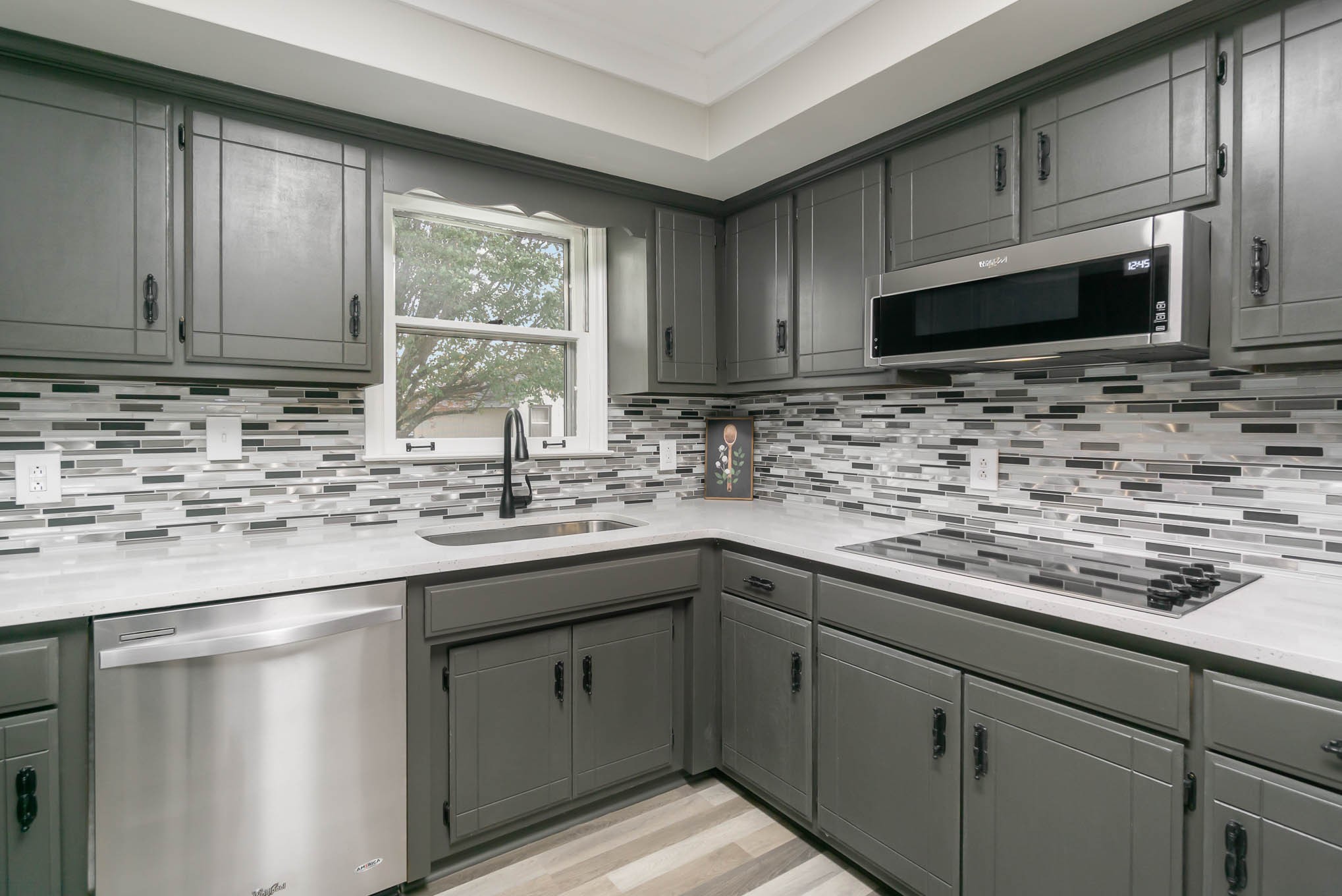 1261 Harrison Road Murfreesboro, TN 37128 - Photo 9 of 24 a kitchen with stainless steel appliances granite countertop a sink stove and microwave