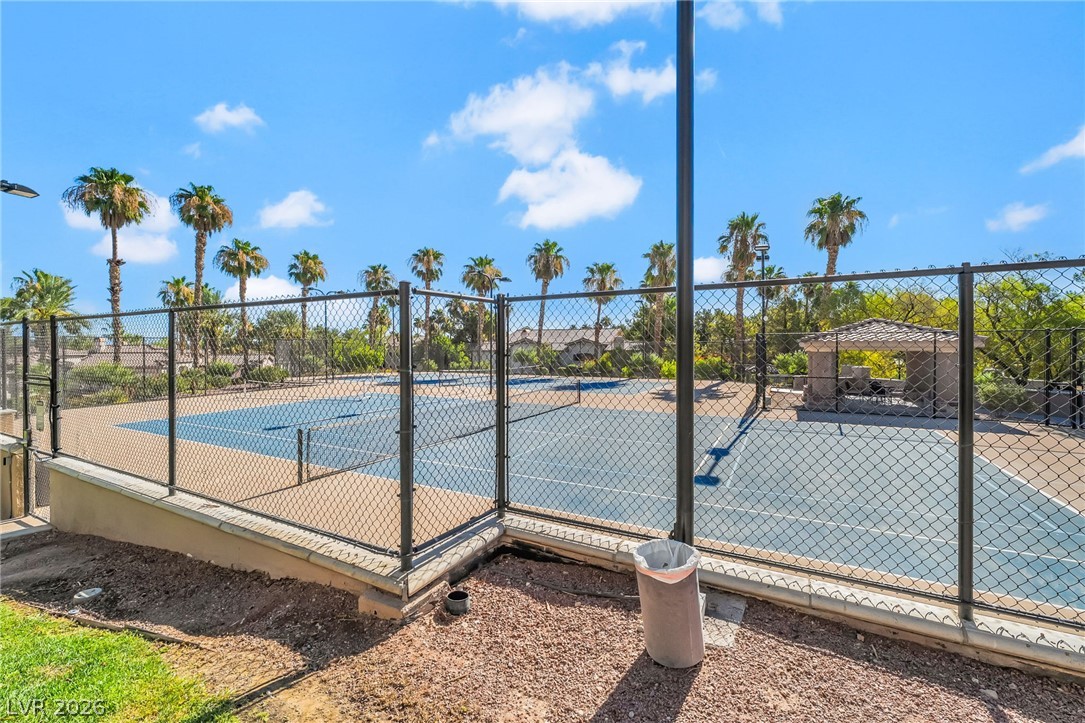 2050 West Warm Springs Road, Unit 2411 Henderson, NV 89014 - Photo 37 of 37 Enjoy active living with the community's well-maintained tennis courts and shaded resting areas, surrounded by lush palm trees.