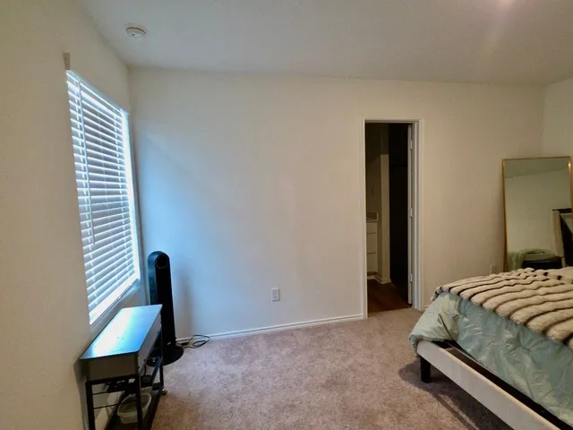 a bedroom with a bed and a chair