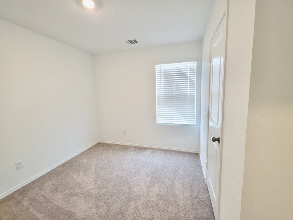 1489 Soapstone Pass Maxwell, TX 78656 - Photo 17 of 20 an empty room with windows