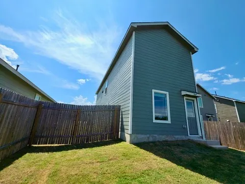 a view of a backyard with sitting area
