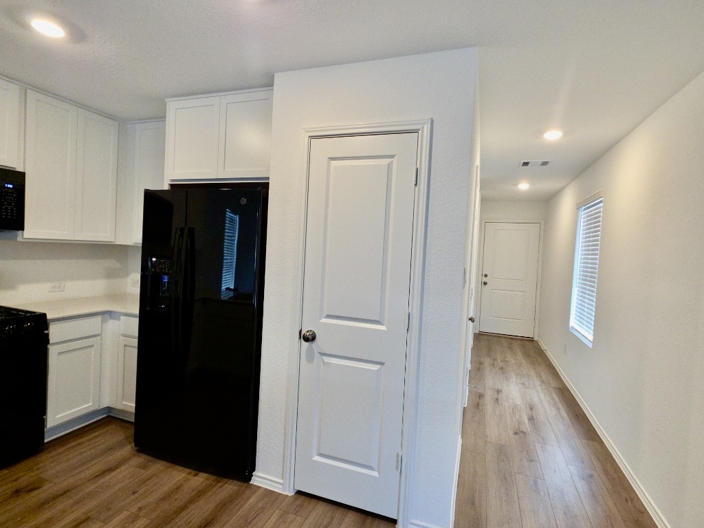 1489 Soapstone Pass Maxwell, TX 78656 - Photo 3 of 20 a view of hallway with wooden floor