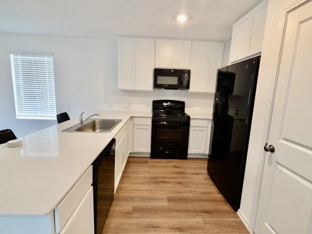 a kitchen with stainless steel appliances a refrigerator and a sink