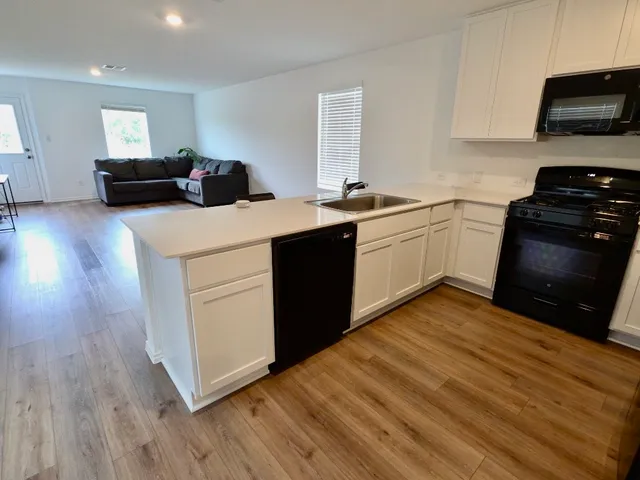a kitchen with a sink and a stove top oven