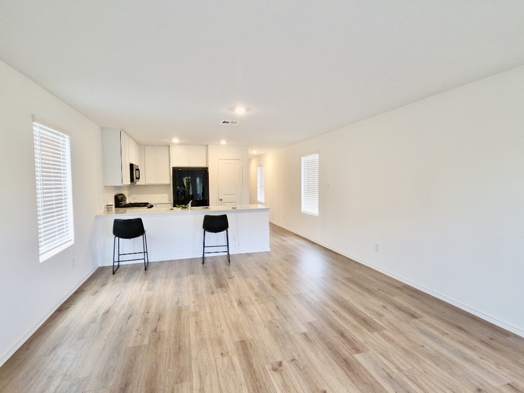 1489 Soapstone Pass Maxwell, TX 78656 - Photo 6 of 20 a living room with furniture and a wooden floor
