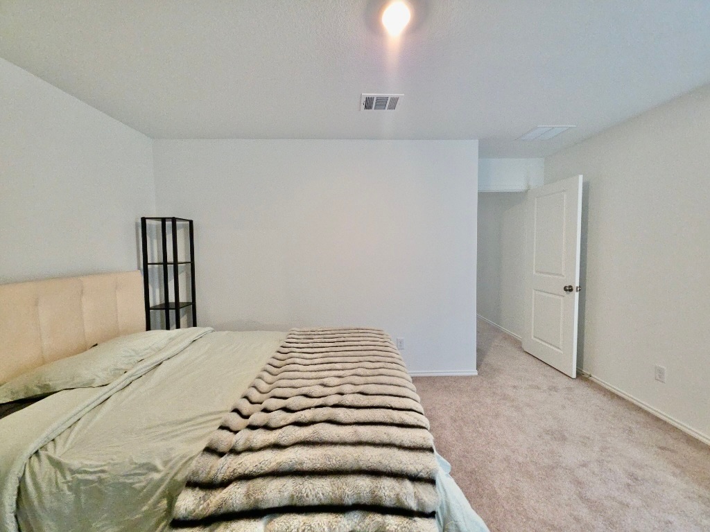 1489 Soapstone Pass Maxwell, TX 78656 - Photo 10 of 20 a bedroom with a bed and wooden floor