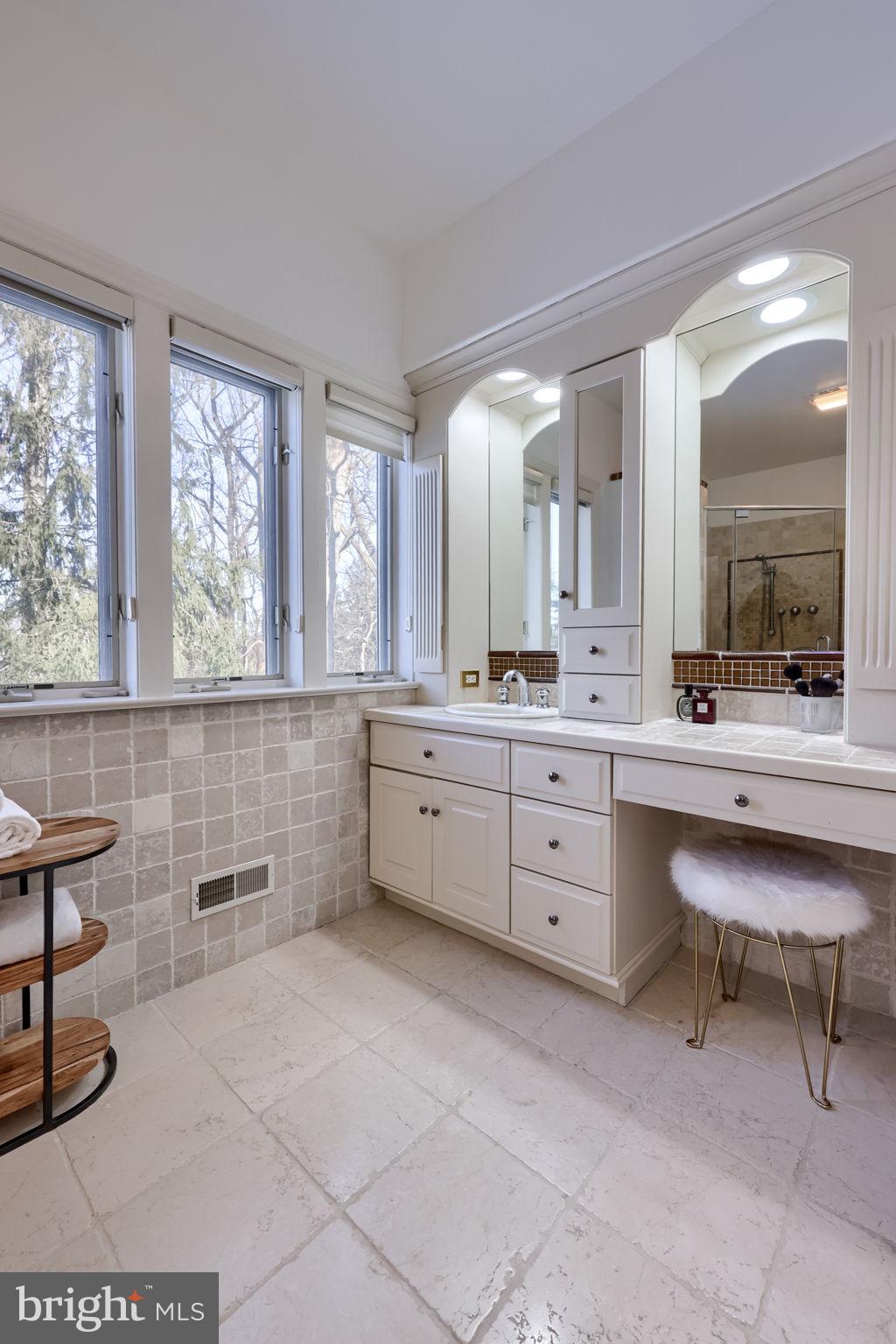 2492 Shaub Road Lancaster, PA 17601 - Photo 43 of 130 a spacious bathroom with a double vanity sink a mirror a bathtub and a window