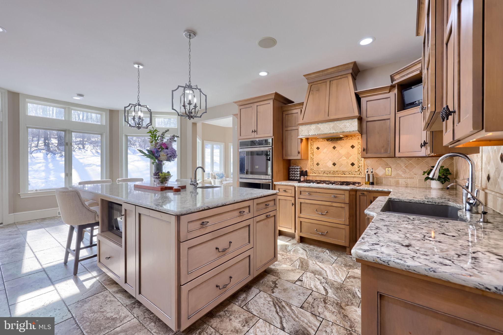2492 Shaub Road Lancaster, PA 17601 - Photo 85 of 130 a kitchen with granite countertop a stove a sink dishwasher a dining table and chairs with wooden floor