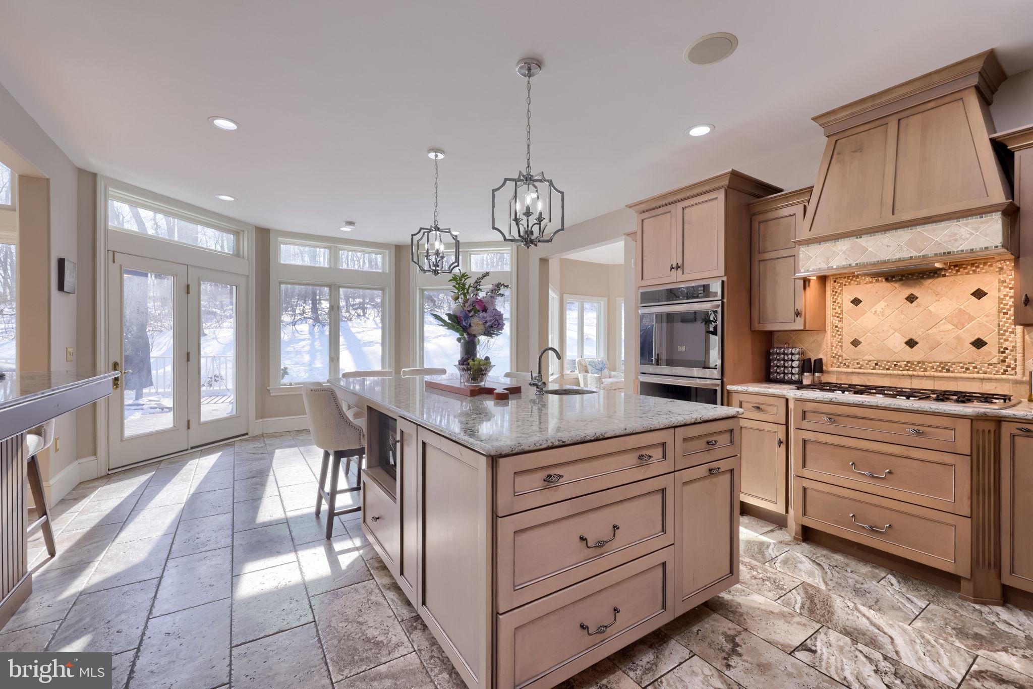 2492 Shaub Road Lancaster, PA 17601 - Photo 87 of 130 a kitchen with granite countertop a stove a sink dishwasher and white cabinets with wooden floor