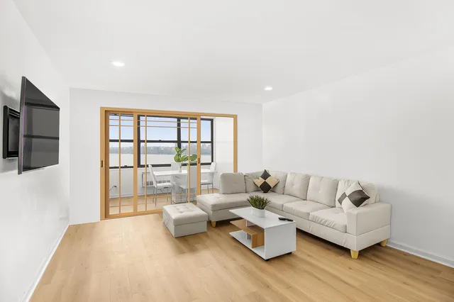 a large white kitchen with sink stainless steel appliances and cabinets