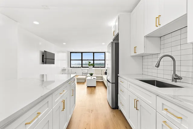 a kitchen with stainless steel appliances a stove a sink and a microwave