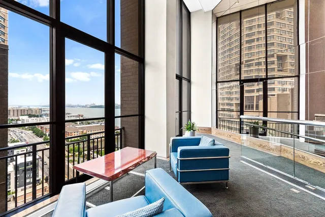 a living room with furniture and a large window