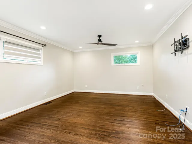a view of a room with wooden floor