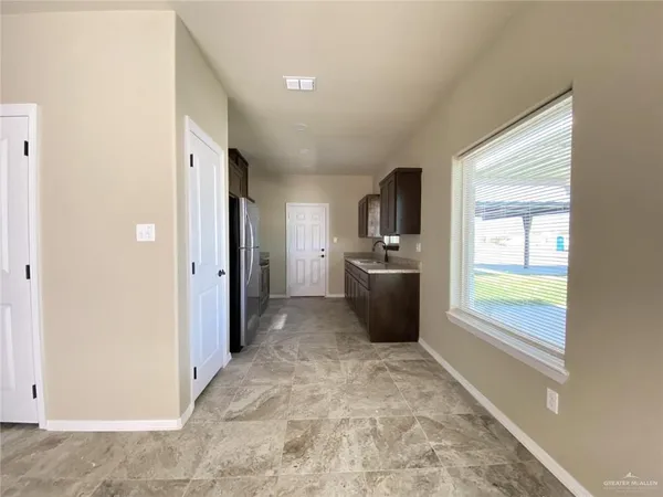 a view of a kitchen cabinets and windows