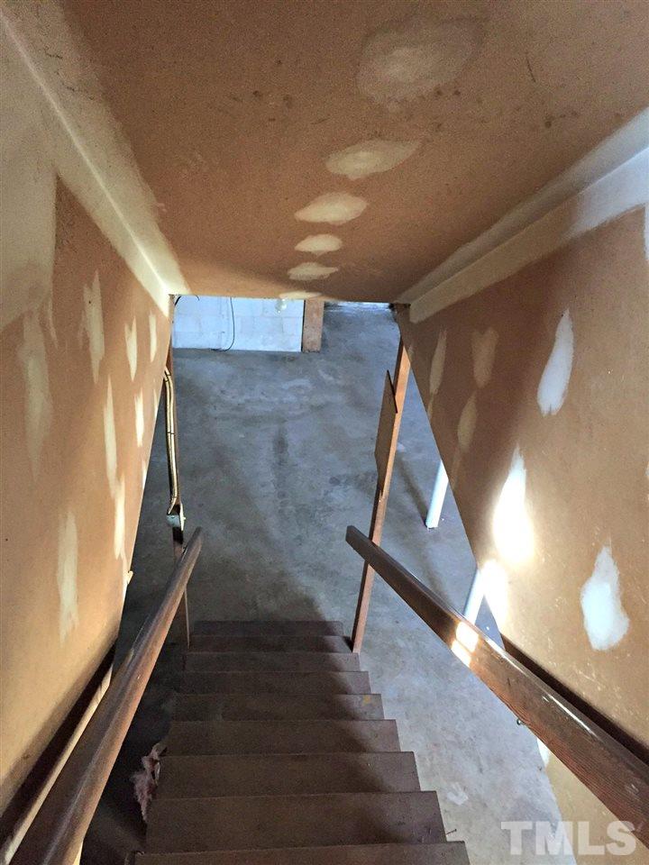 3128 Gibson Road Durham, NC 27703 - Photo 15 of 19 These interior stairs lead to full basement below.