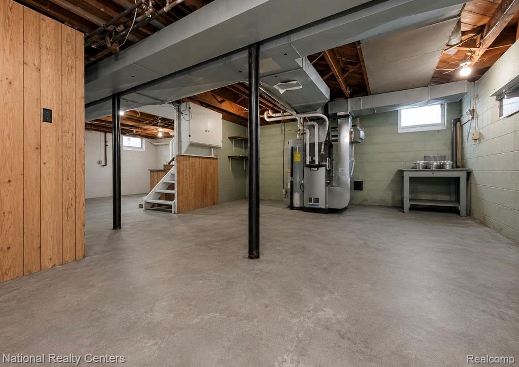 7285 Helen Street Center Line, MI 48015 - Photo 25 of 32 Spacious basement area featuring a concrete floor, exposed ceiling joists, and block wall construction