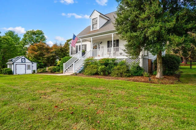 a kitchen with wooden floors and white cabinets