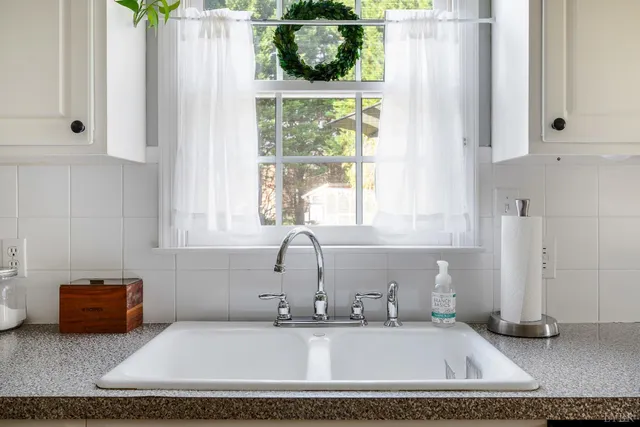 a bedroom with a bed chandelier and a window