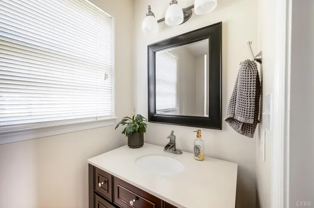 a view of an empty room with a window and a ceiling fan