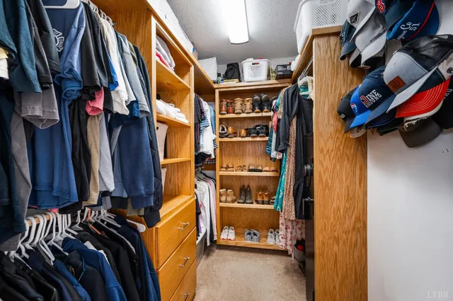 a view of a bedroom with wooden floor and windows