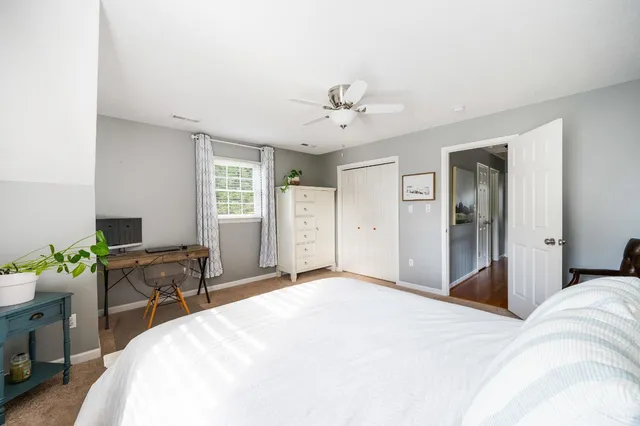a view of an entryway with wooden floor and a livingroom