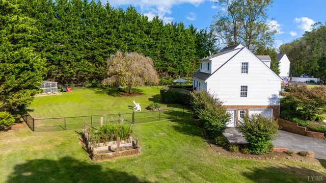a view of a house with a yard and garage