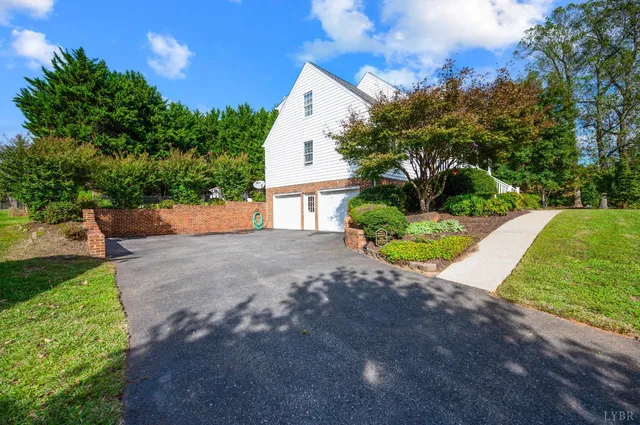 a view of a house with a yard and sitting area