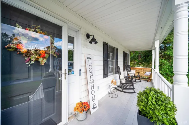 a balcony with chairs and wooden floor