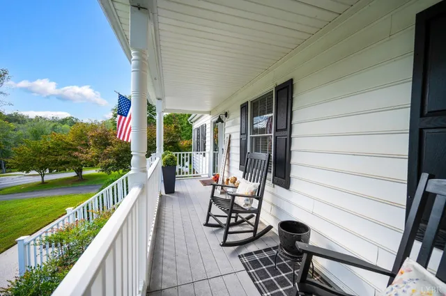 a view of a house with backyard porch and sitting area