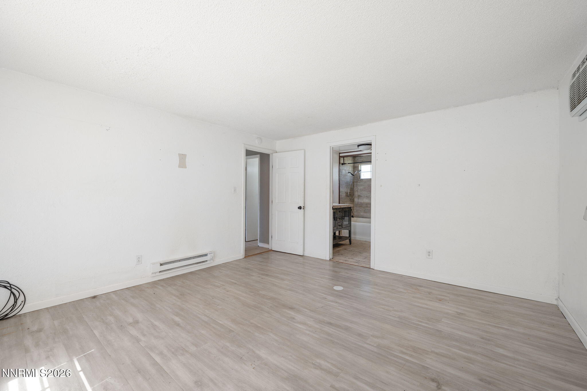 3590 Siskin Lane Reno, NV 89508 - Photo 21 of 31 an empty room with wooden floor and windows